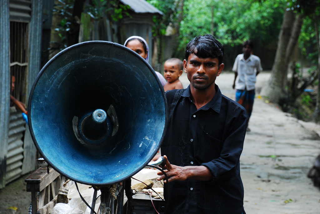 A villager in rural Bangladesh tests a community-driven early warning system. Credit: UNISDR