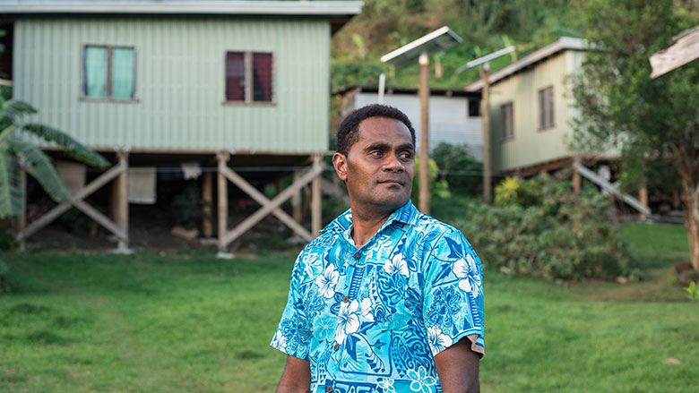 Sepesa ‘Kili’ Kilimo in front of his new home, one of four provided as part of a partial relocation of Vunisavisavi.