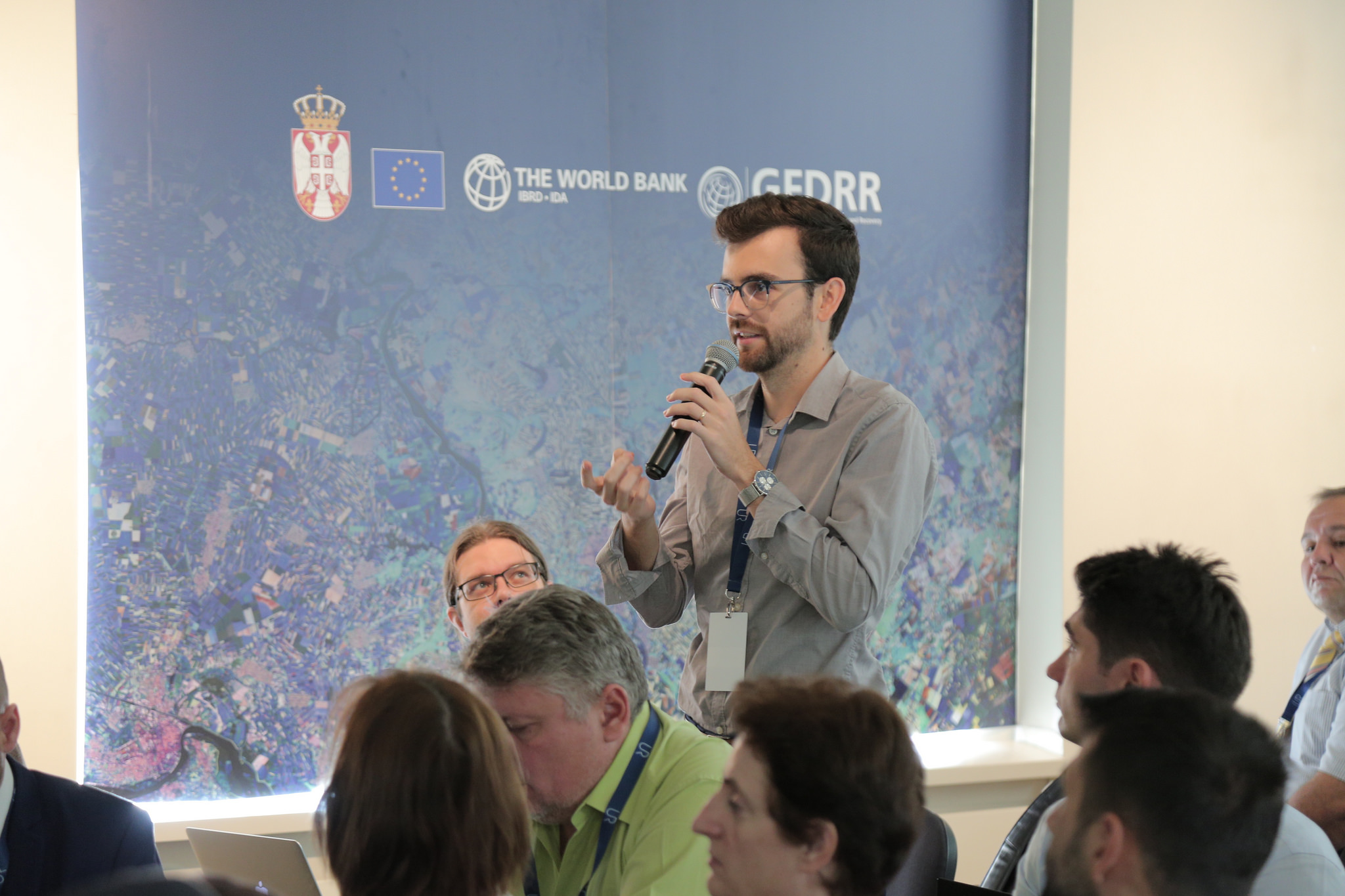 A participant poses a question during the session on community resilience.