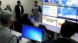 Group of workers viewing a seismology presentation on a large screen